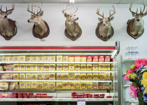 Image of Deer Heads over Meat Display, GA